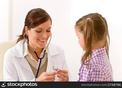 Female doctor examining child with stethoscope at surgery