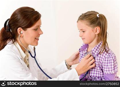 Female doctor examining child with stethoscope at surgery