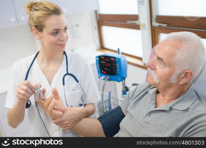 female doctor examining patient blood pressure