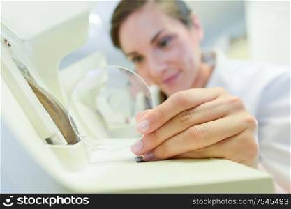female doctor fixes glasses in the laboratory