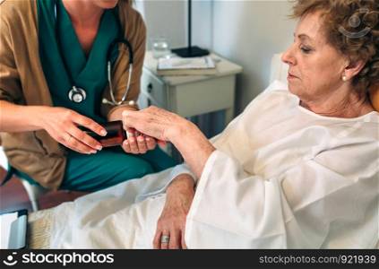 Female doctor giving medication dose to elderly patient. Doctor giving medication dose to elderly patient