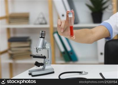 female doctor hand holding blood sample