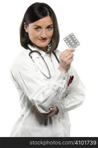 Female doctor handing medicine isolated on white
