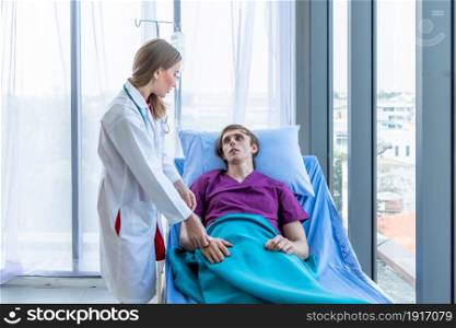 female doctor hold the leg to heal the illness to a man patient on bed with symptom in hospital background,healthcare,medicine concept
