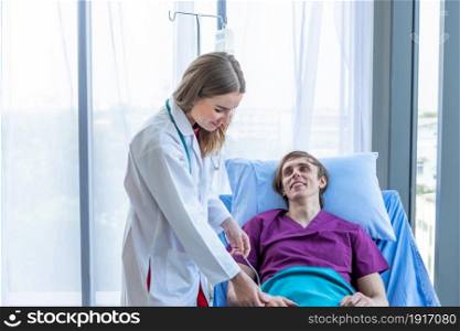 female doctor hold the leg to heal the illness to a man patient on bed with symptom in hospital background,healthcare,medicine concept