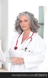 female doctor holding a laptop