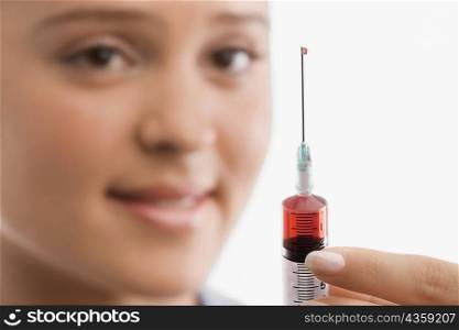 Female doctor holding a syringe