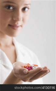 Female doctor holding pills