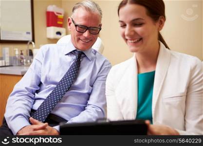 Female Doctor In Consultation With Male Patient