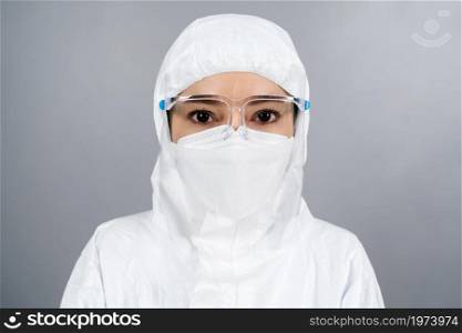 female doctor in protective PPE suit wearing face mask and face shield protection from coronavirus(covid-19) pandemic