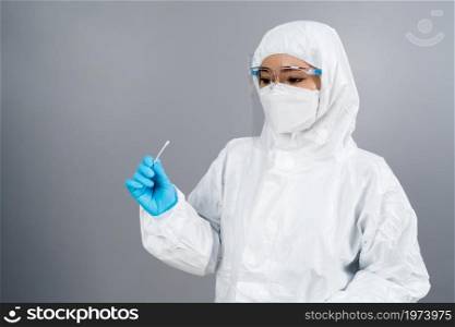 female doctor in protective suit PPE holding Coronavirus(COVID-19) Nasal swab laboratory test
