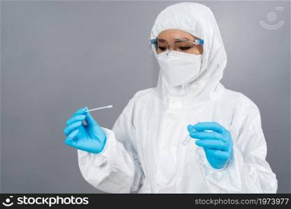 female doctor in protective suit PPE holding Coronavirus(COVID-19) Nasal swab laboratory test
