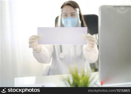 Female Doctor In Uniform Shows a blank paper signage empty board white. Epidemic pandemic spreading coronavirus 2019-ncov sars covid-19 flu virus concept