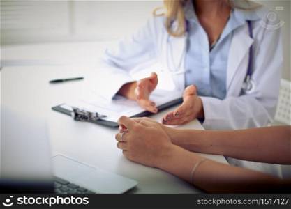 Female doctor interviewing female patient. No faces