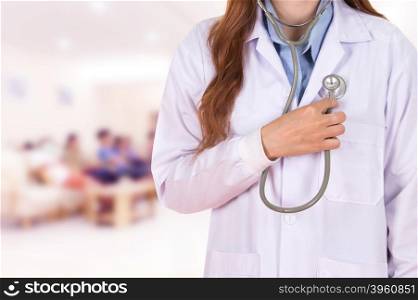 female doctor listening his heart with stethoscope in hospital background