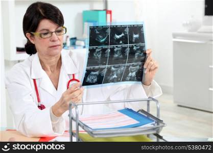 Female doctor looking at an xray