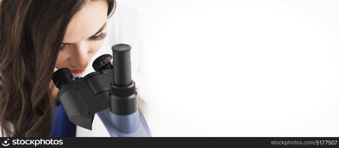 Female doctor looking through a microscope. Female doctor looking through a microscope, studio shot isolated on white background