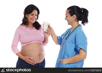 Female doctor offering a glass of milk to a beautiful pregnant