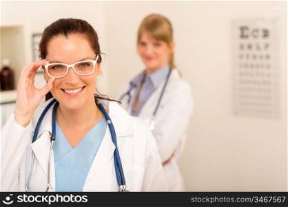 Female doctor ophthalmologist with funny white glasses looking at camera