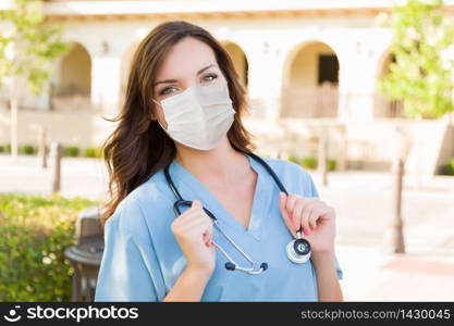 Female Doctor or Nurse Wearing Protective Face Mask Outside.