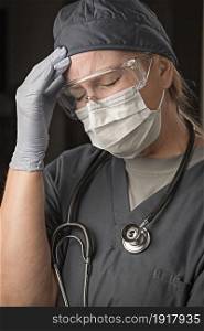 Female Doctor or Nurse Wearing Scrubs, Protective Face Mask and Goggles.