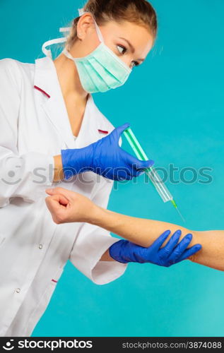 Female doctor or nurse with syringe giving injection to patient. Medical person for health insurance.