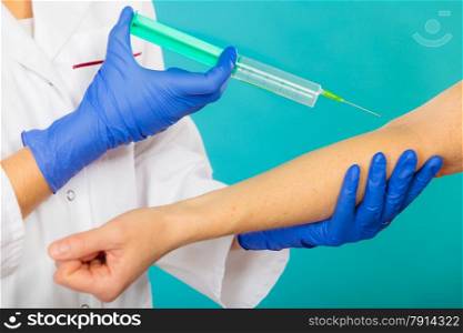 Female doctor or nurse with syringe giving injection to patient. Medical person for health insurance.