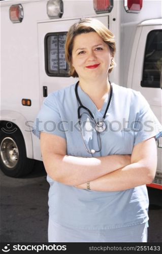 Female doctor or paramedic in front of an ambulance