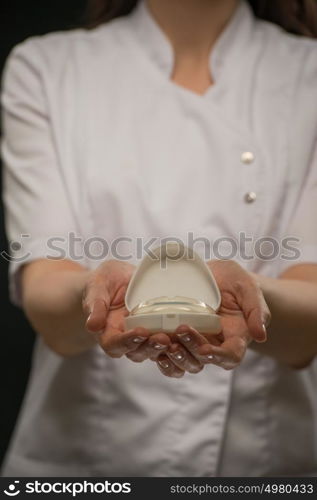 Female doctor orthodontist showing mouthguard teeth dental trainer