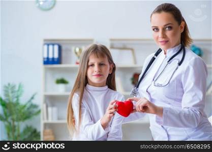 Female doctor pediatrician checking girl