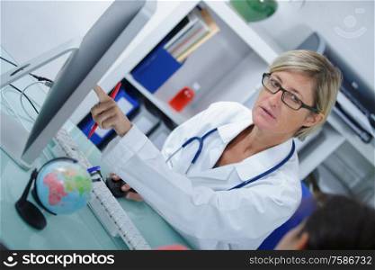 female doctor pointing to computer