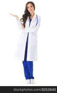 Female doctor showing blank area. Full body portrait of happy smiling young female doctor showing something or blank area for text, or copyspace, isolated over white background
