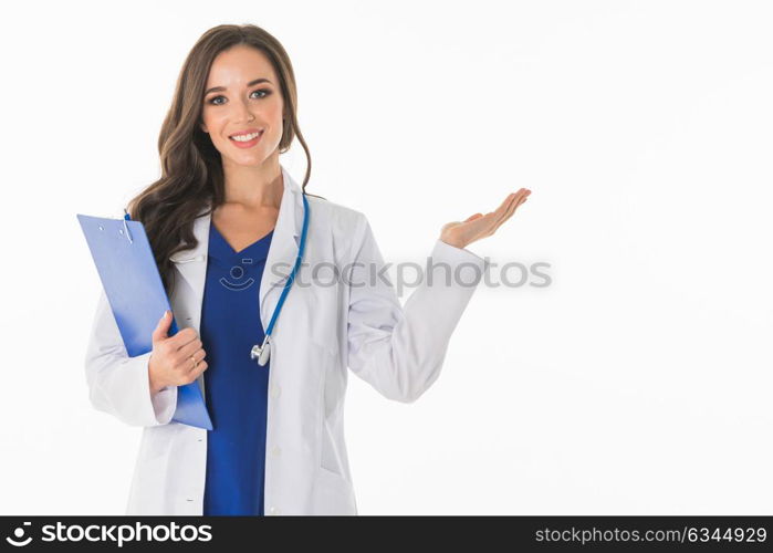 Female doctor showing something. Portrait of happy smiling young female doctor showing something or blank area for text, or copyspace, isolated over white background