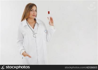 female doctor showing tube filled with blood
