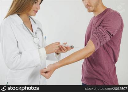 female doctor taking blood from patient