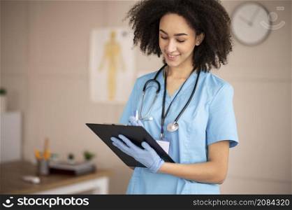 female doctor taking notes clipboard