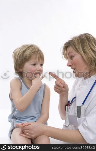 Female Doctor Talking To A Little Boy