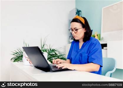 Female doctor using the laptop in the clinic