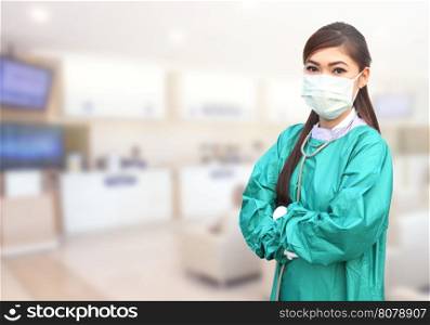 female doctor wearing a green scrubs and stethoscope in hospital background
