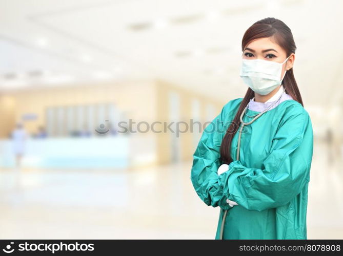 female doctor wearing a green scrubs and stethoscope in hospital background