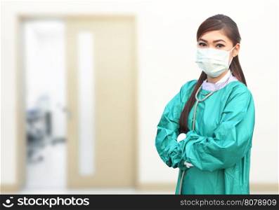 female doctor wearing a green scrubs and stethoscope in hospital background