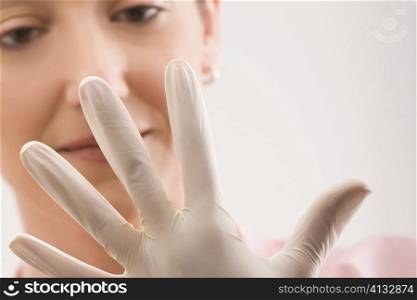 Female doctor wearing a surgical glove