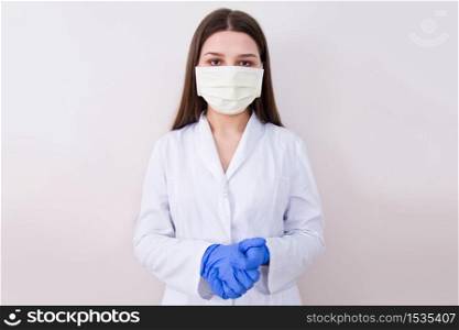 Female doctor wearing protection face mask and gloves. Covid-19 concept.