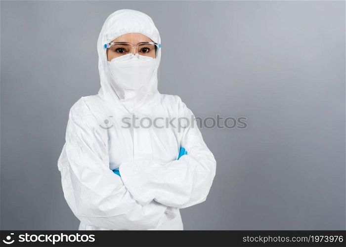 female doctor with crossed arms, wearing PPE suit against coronavirus(covid-19) pandemic