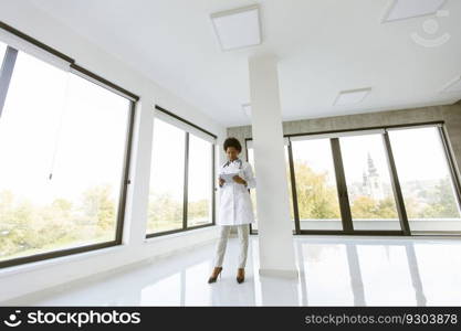 Female doctor with digital tablet in the empty medical office