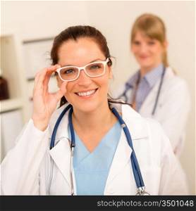 Female doctor with funny white glasses looking at camera