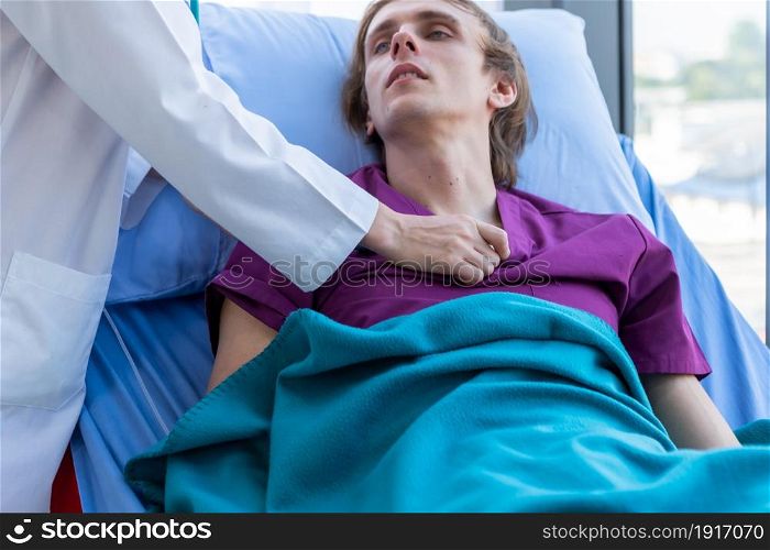 female doctor with hands of checking examining his pulse to a man patient on bed for record the treatment results with smiley face very good symptom in hospital background.