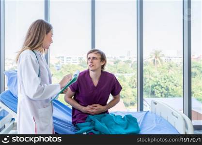female doctor with hands of checking man patient having has gotten a severe stomach ache lying on bed for record the treatment results with smiley face very good symptom in hospital background.