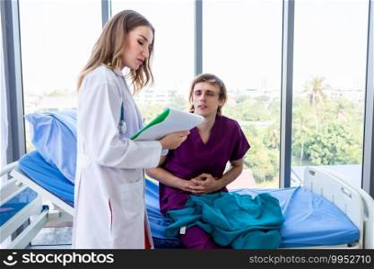 female doctor with hands of checking man patient having has gotten a severe stomach ache lying on bed for record the treatment results with smiley face very good symptom in hospital background.
