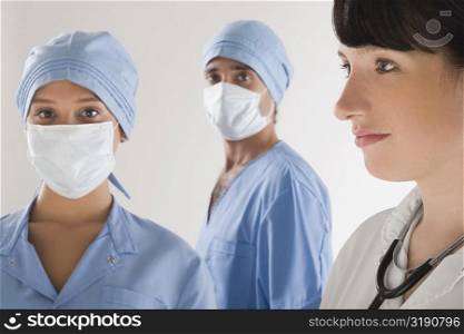 Female doctor with two surgeons